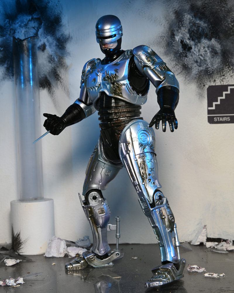 RoboCop Actionfigur Ultimate Battle Damaged RoboCop with Chair 18 cm - Preorder - ETA: 16.02.2026
